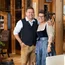 Lächelndes Paar in traditioneller Tracht in einem gemütlichen Holzinterieur